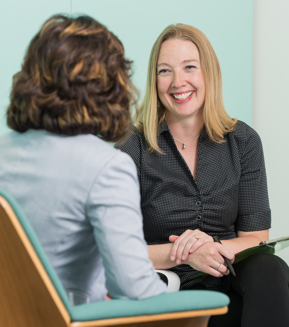 A smiling patient talking with a Spira Care consultant.